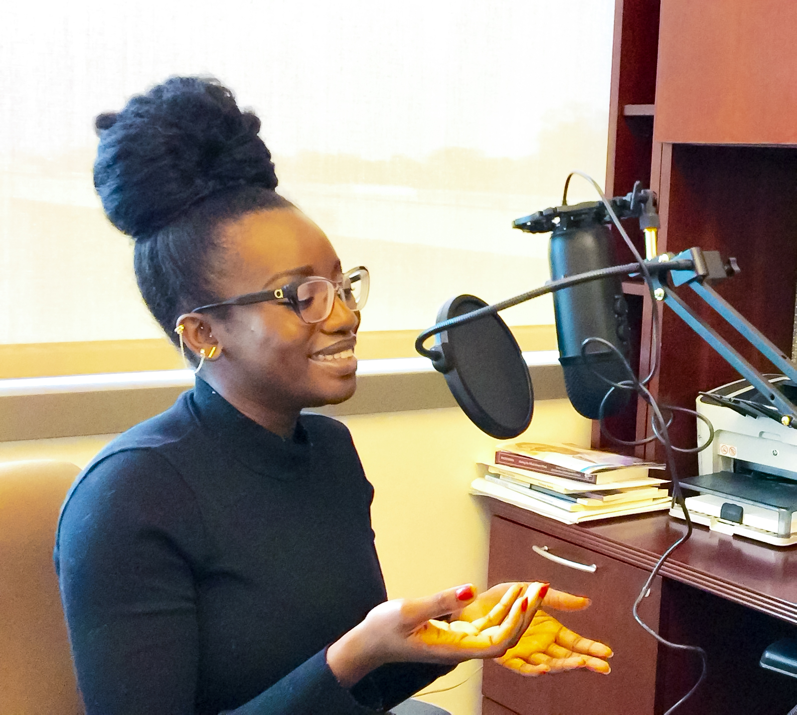 Graduate Assistant Martha Duah interviewing during podcast