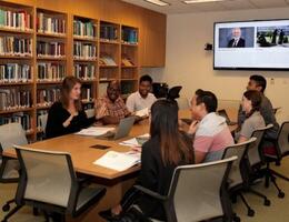 group of people in library around table
